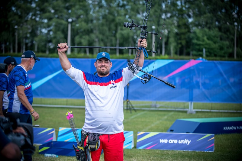 Jozef Bosansky holding up a RamRods Archery stabilizer after winning the world cup